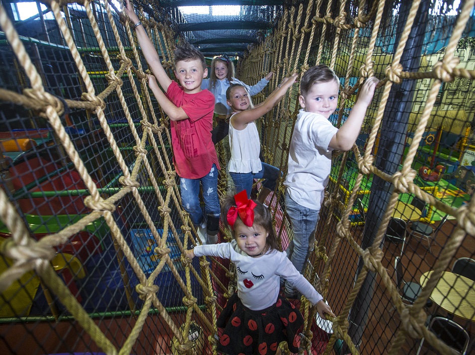 Kids climbing across rope bridge at Indiana Land