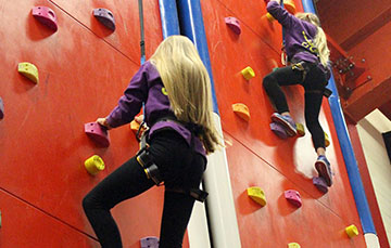 Two girls on climbing wall
